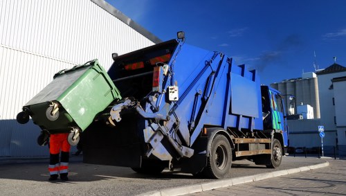 Construction site with builders waste being cleared in Woodford Green