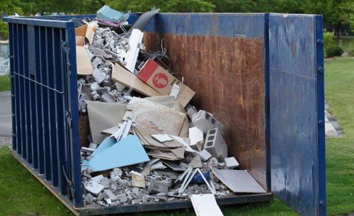 Builders clearing waste from a construction site in West Ealing