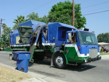 Truck and workers handling construction debris