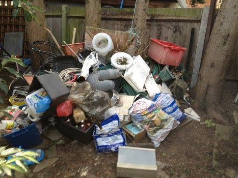 Professional waste clearance team assessing construction debris.