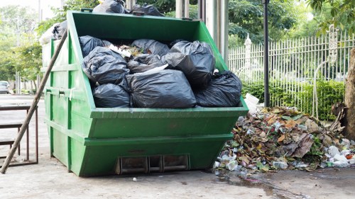 Waste clearance professionals assessing construction waste